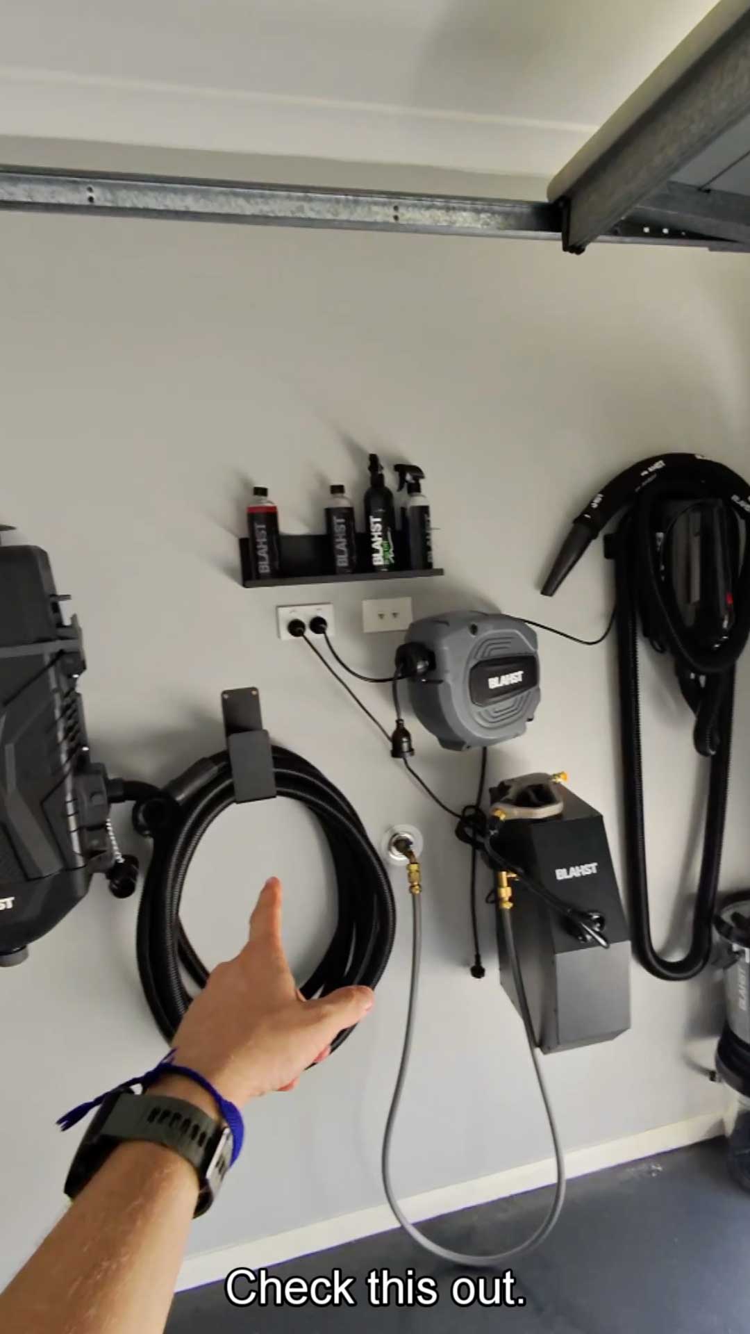BLAHST pressure washer setup mounted on a garage wall
