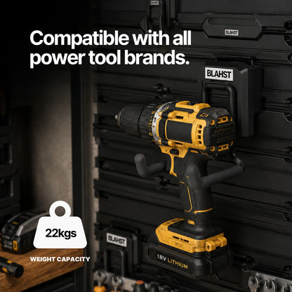 Yellow and black cordless drill hanging from a BLAHST Modular Power Tool Hook on a wall panel