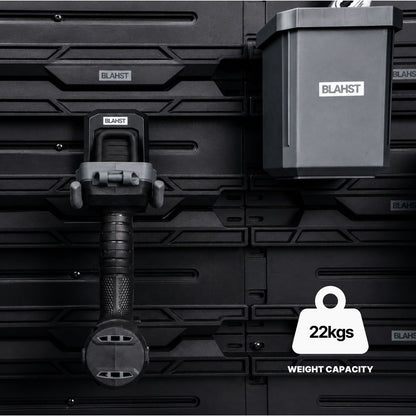 Close-up of a BLAHST Modular Power Tool Hook and tub mounted on a rail holding a tool handle