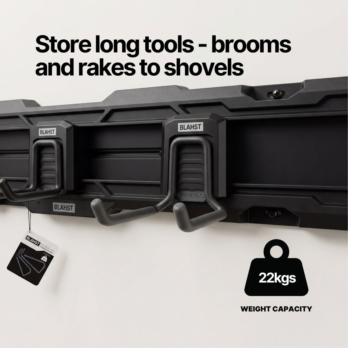 Two BLAHST Modular Power Tool Hooks mounted on a rail holding broom and rake handles