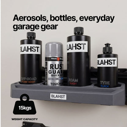 Cleaning bottles and a spray can stored in a BLAHST Modular Bottle Holder mounted on a rail