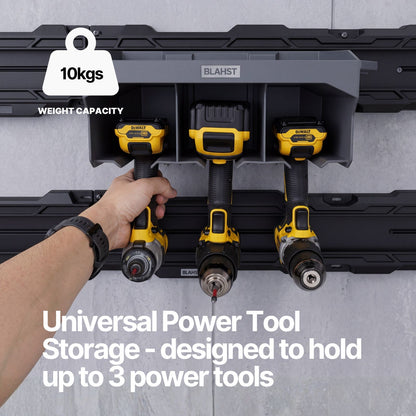 Three cordless drills stored in a BLAHST Modular Power Tool Holder mounted on a wall