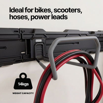 Red and black cables hanging from a BLAHST Modular Wide Hook mounted on a garage wall rail