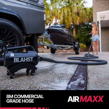 Man drying a dirt bike with a BLAHST Air Maxx Dryer nozzle in a garage